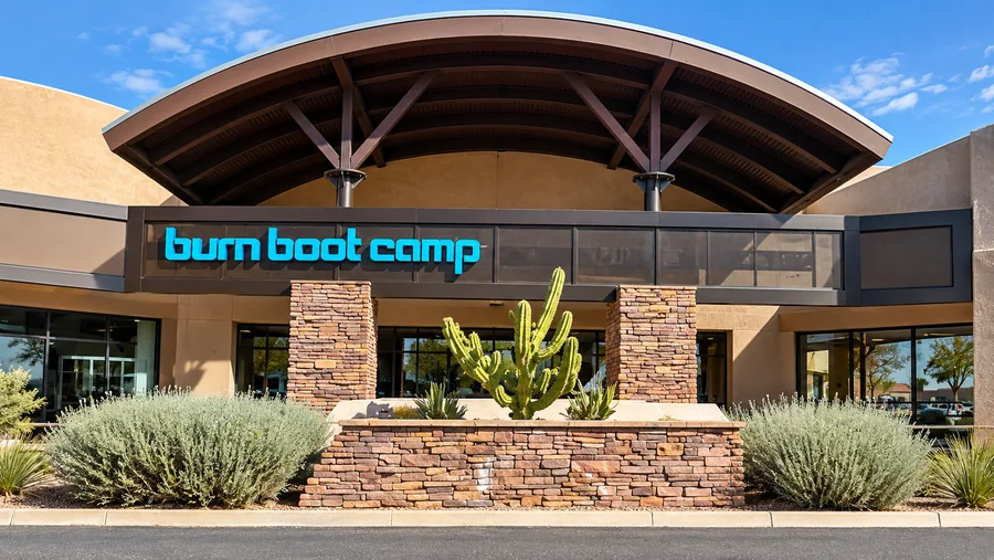 Burn Boot Camp: Finished Burn Boot Camp storefront with readable blue sign, stone facade and desert landscaping