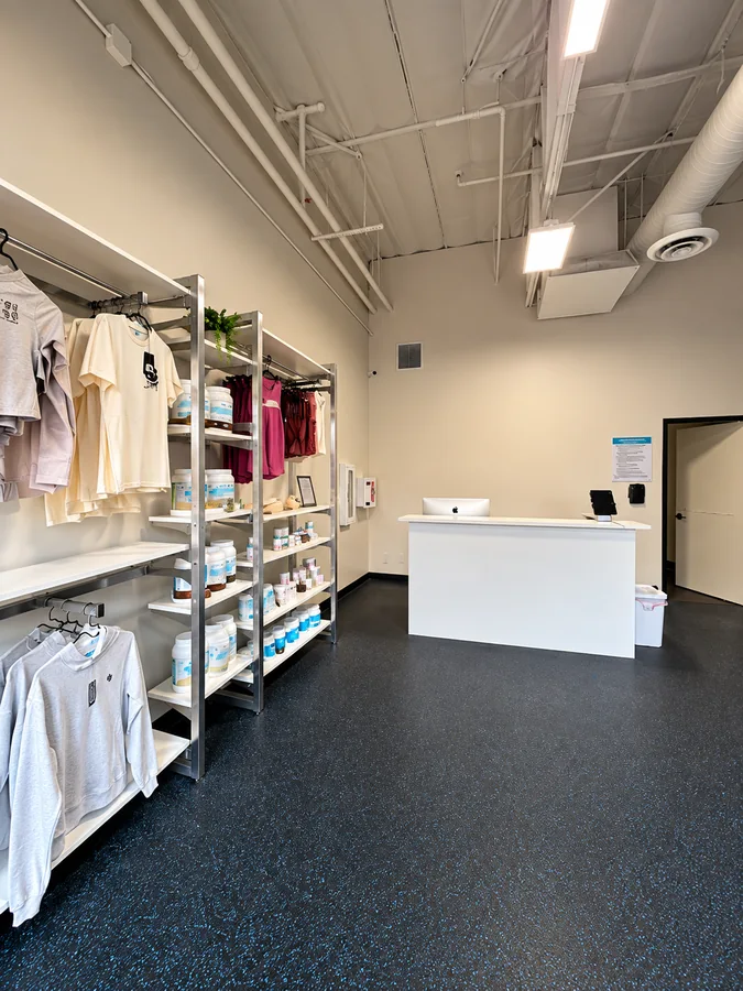 Burn Boot Camp: Finished reception/check-in area with retail apparel shelves and white desk