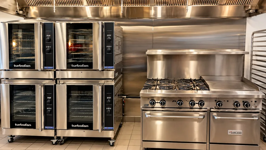 Let’s Toast Restaurant: Finished commercial cooking line with stacked ovens, range and stainless extraction hood