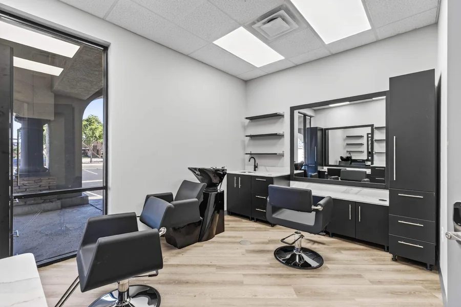 Wild Souls Salon Suites: Window-side salon suite at Wild Souls with styling chair and cabinetry